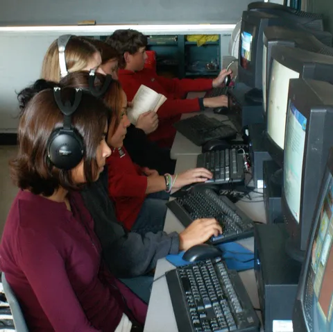 Several of Bob's students training together on headphones and classroom computers