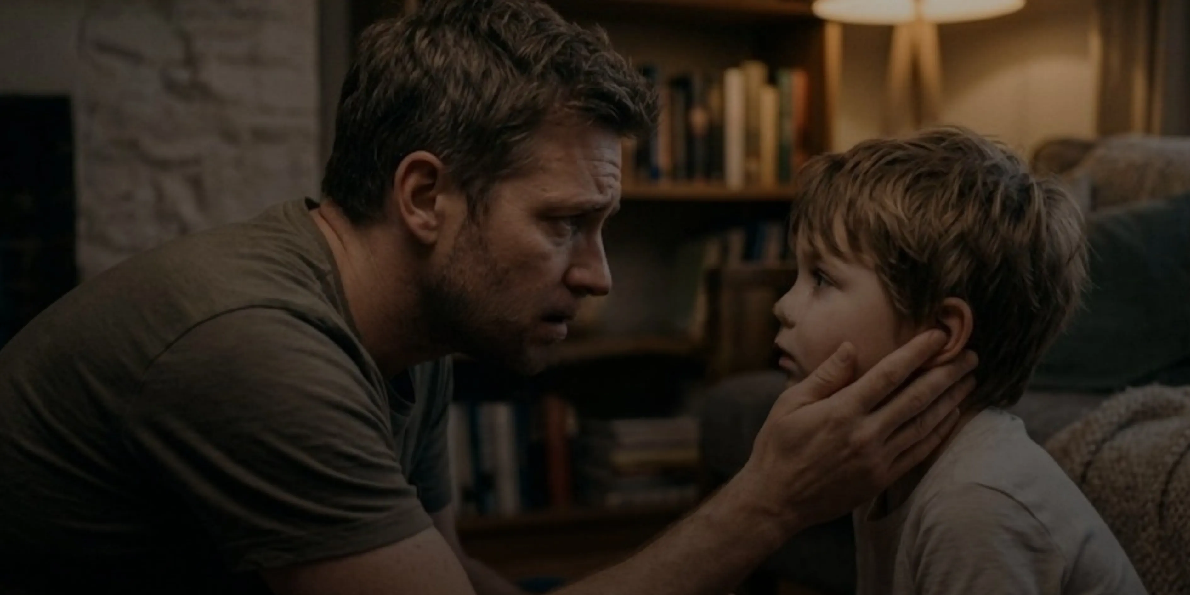 A father crouches down to reassure his son.